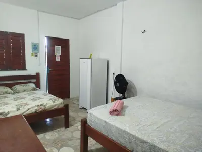 Uma cama ou camas num quarto em Pousada Praiamar