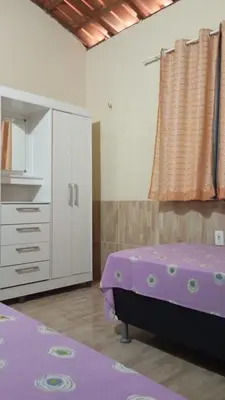 Uma cama ou camas num quarto em Condominio Nina