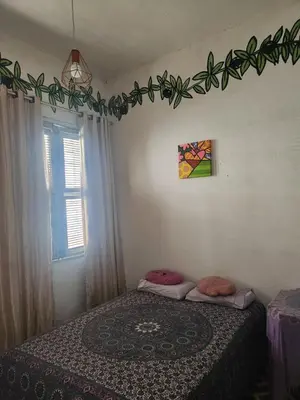 Uma cama ou camas num quarto em Quarto em casa aconchegante no Benfica