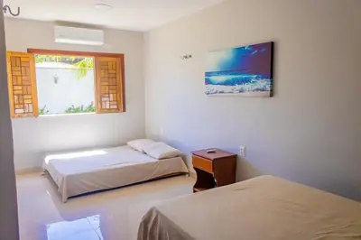Uma cama ou camas num quarto em Belíssima casa na praia do Morro Branco