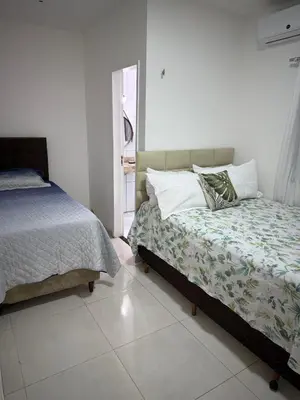 Uma cama ou camas num quarto em Casa em Fortaleza