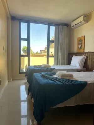 Uma cama ou camas num quarto em Varandas do Mar - Beachfront Apartment