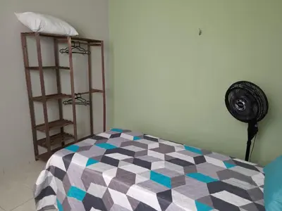 Uma cama ou camas num quarto em Casa Verde Marinho - Sossego no Jacarecanga