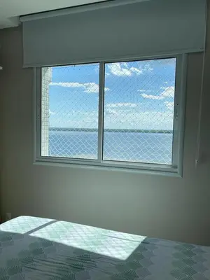 Uma cama ou camas num quarto em Apartamento com vista para o mar - Caravelli