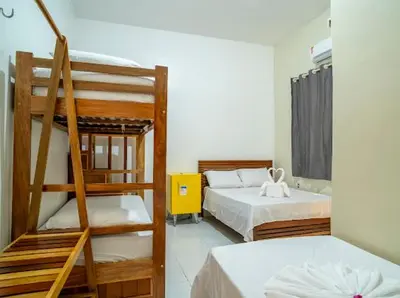 Uma cama ou camas num quarto em Suítes Pe na Areia