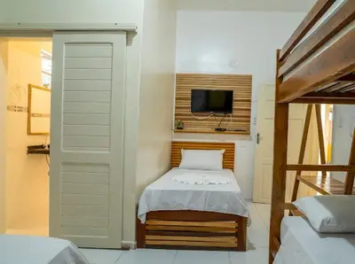 Uma cama ou camas num quarto em Suítes Pe na Areia