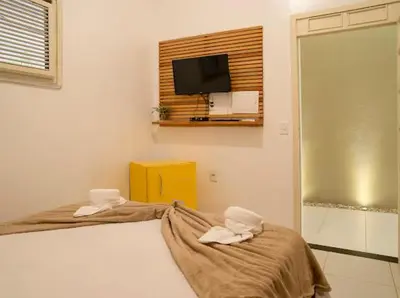 Uma cama ou camas num quarto em Suítes Pe na Areia