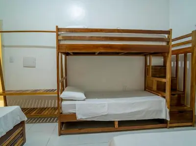 Uma cama ou camas num quarto em Suítes Pe na Areia
