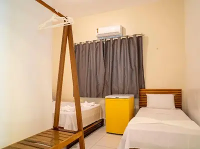 Uma cama ou camas num quarto em Suítes Pe na Areia