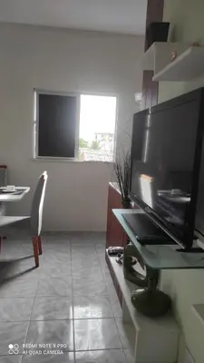 Uma televisão e/ou sistema de entretenimento em Apartamento em Fortaleza