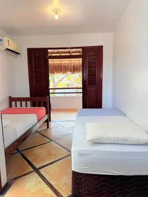 Uma cama ou camas num quarto em Pousada Calamarina