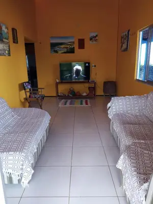Uma cama ou camas num quarto em Casa vista mar, perfeita para família e amigos