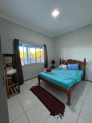 Uma cama ou camas num quarto em Casa vista mar, perfeita para família e amigos