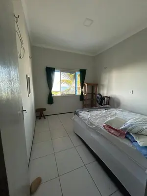 Uma cama ou camas num quarto em Casa vista mar, perfeita para família e amigos