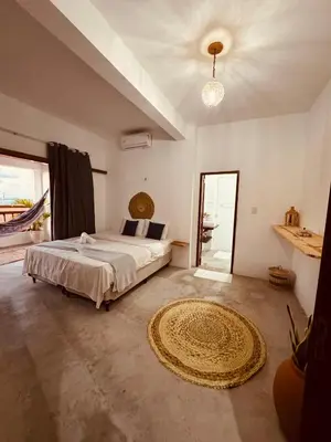 Uma cama ou camas num quarto em Lu Pousada Charme Preá