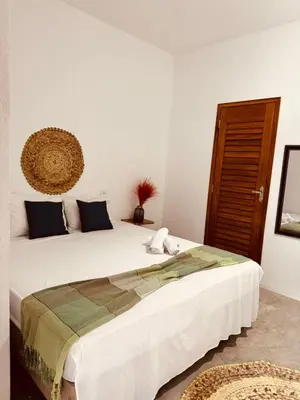 Uma cama ou camas num quarto em Lu Pousada Charme Preá