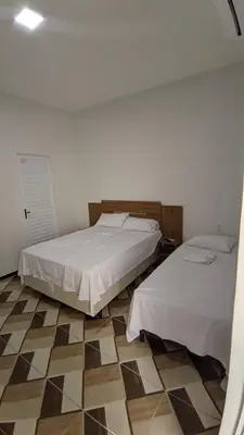 Uma cama ou camas num quarto em Pousada Garrida