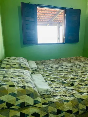 Uma cama ou camas num quarto em Casa Mar Poesia - Taiba