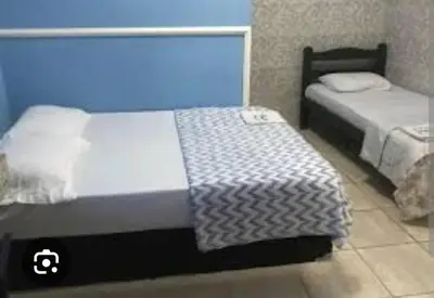 Uma cama ou camas num quarto em Pousada Beija-Flôr Aeroporto