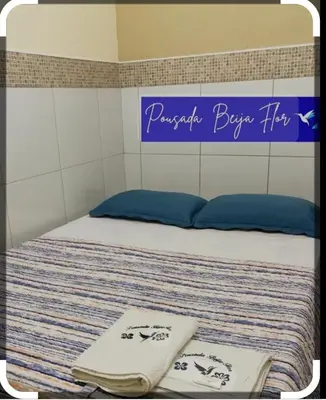 Uma cama ou camas num quarto em Pousada Beija-Flôr Aeroporto