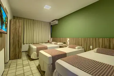Uma cama ou camas num quarto em Mansão14Suítes-55Pessoas-BEACH PARK - HOUSINGCEARÁ