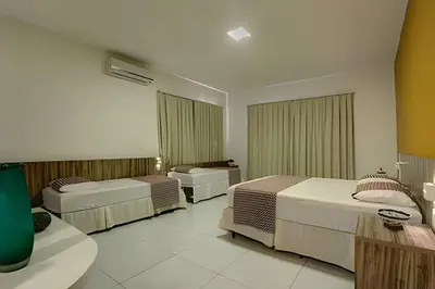 Uma cama ou camas num quarto em Mansão14Suítes-55Pessoas-BEACH PARK - HOUSINGCEARÁ
