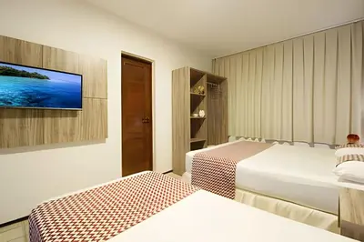 Uma cama ou camas num quarto em Mansão14Suítes-55Pessoas-BEACH PARK - HOUSINGCEARÁ