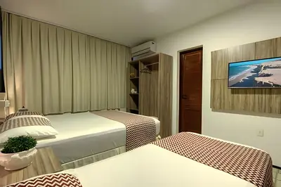 Uma cama ou camas num quarto em Mansão14Suítes-55Pessoas-BEACH PARK - HOUSINGCEARÁ