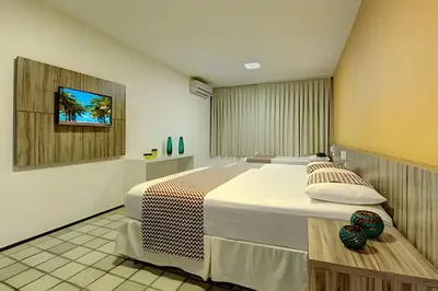 Uma cama ou camas num quarto em Mansão14Suítes-55Pessoas-BEACH PARK - HOUSINGCEARÁ