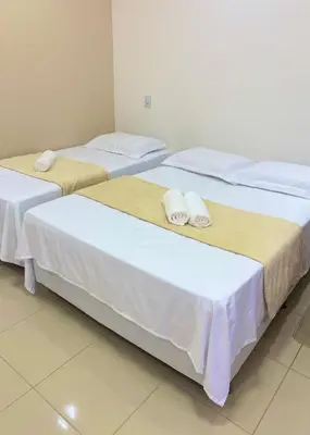 Uma cama ou camas num quarto em Suite no Centro da Praia de Flecheiras