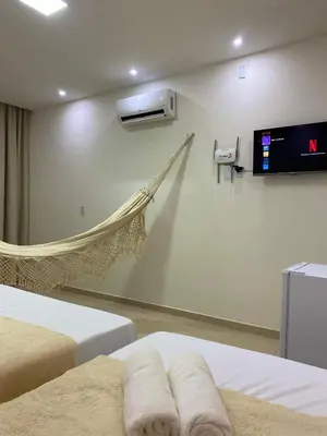 Uma cama ou camas num quarto em Suite no Centro da Praia de Flecheiras