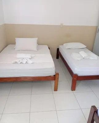 Uma cama ou camas num quarto em Pousada Sol do Centro