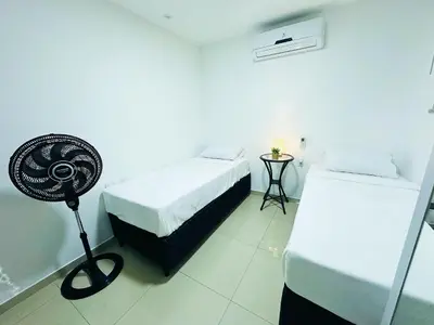 Uma cama ou camas num quarto em Happy Living Praia do Futuro