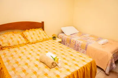 Uma cama ou camas num quarto em Casa de Hospedagem Cajueiro