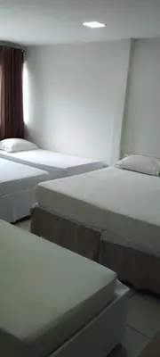 Uma cama ou camas num quarto em Nalu Beach Hotel pousada