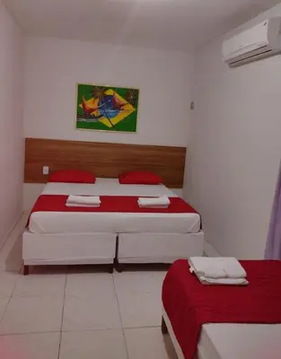Uma cama ou camas num quarto em Nalu Beach Hotel pousada