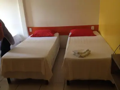 Uma cama ou camas num quarto em Nalu Beach Hotel pousada