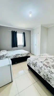 Uma cama ou camas num quarto em Flat Paulista 10