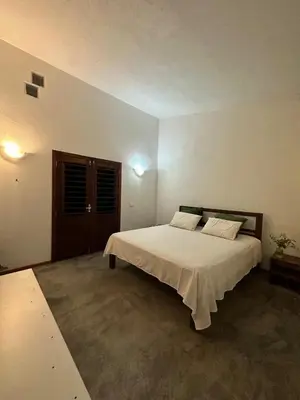 Uma cama ou camas num quarto em Chalezinho da Mari