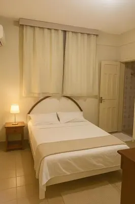 Uma cama ou camas num quarto em Hotel Lídia