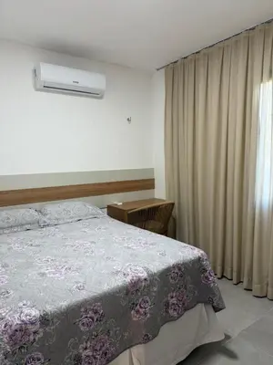 Uma cama ou camas num quarto em Apart Serra Bella Guaramiranga