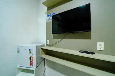 Uma televisão e/ou sistema de entretenimento em Flat c Wi-Fi e Ar-condicionado Perto do Aeroporto