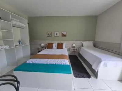 Uma cama ou camas num quarto em Residencial New Stilo-Falésia