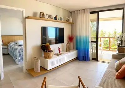 Uma televisão e/ou sistema de entretenimento em Seu Refúgio Pé na Areia
