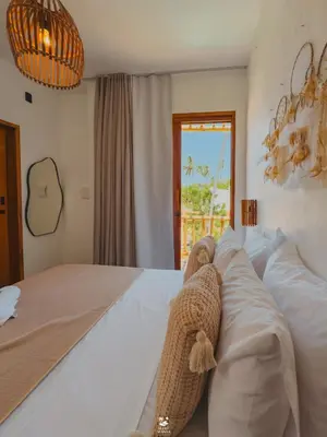 Uma cama ou camas num quarto em Maré Mansa Suítes Icaraizinho