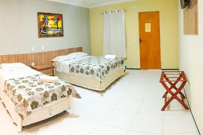 Uma cama ou camas num quarto em Pousada Itarema Residence