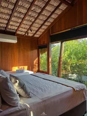 Uma cama ou camas num quarto em Vila Moitas Casa TUPI