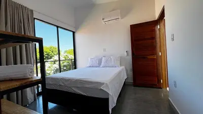 Uma cama ou camas num quarto em Chalés da Bica - Modernidade e Aconchego a 100m da Praia