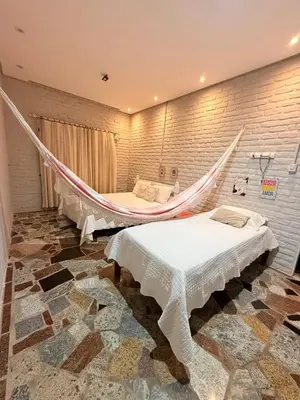 Uma cama ou camas num quarto em Paraíso da Barra House