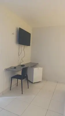 Uma televisão e/ou sistema de entretenimento em Pousada Use Sabor Caseiro